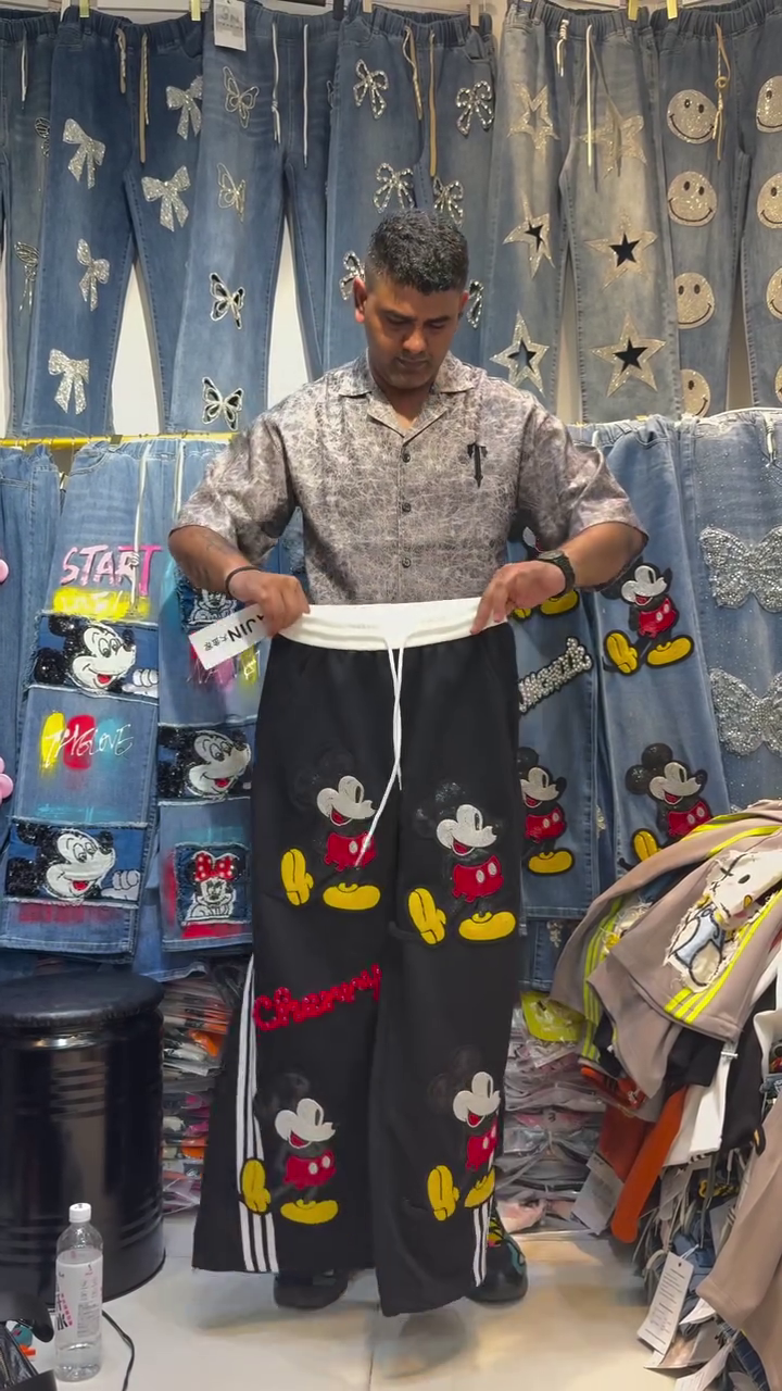 Trendy Wide-Leg Cartoon Print Pants with Sparkling Bow Details and Bold Red Accents for a Fun Streetwear Look