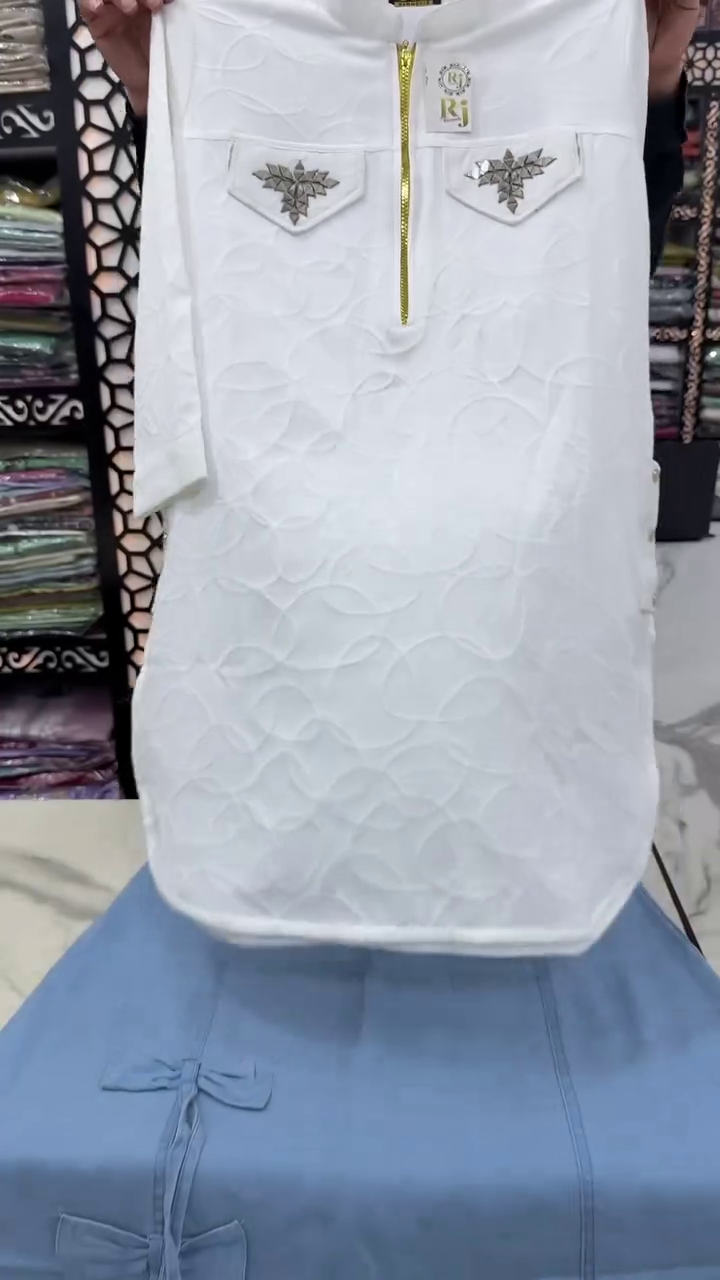 Elegant White Textured Kurta with Golden Zipper and Embellished Pockets Paired with a Stylish Light Blue Bottom