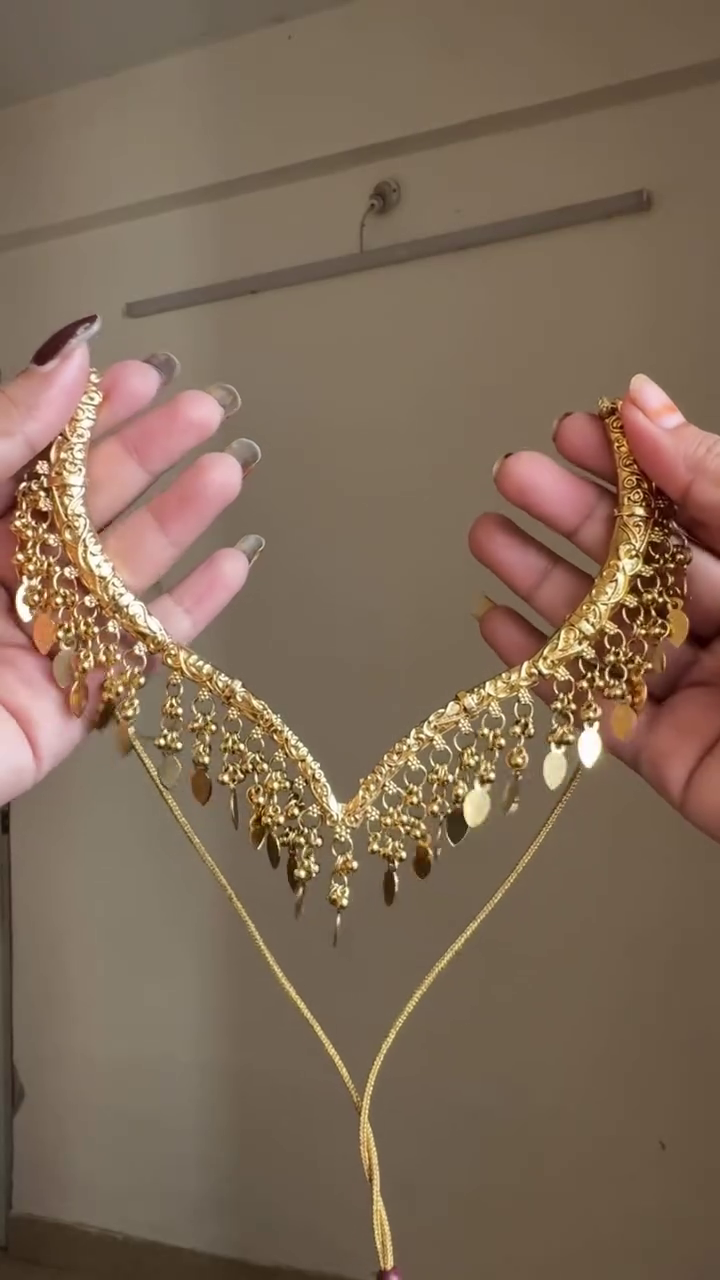 Elegant Traditional Gold-Tone Necklace with Intricate Antique Detailing and Beautiful Dangling Charms for Wedding and Festive Wear